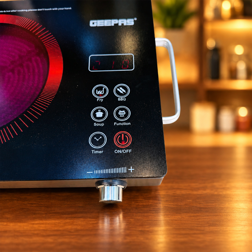 GEEPAS GIC-6921NV UK fused plug close-up with infrared cooker glowing in background - Showroom